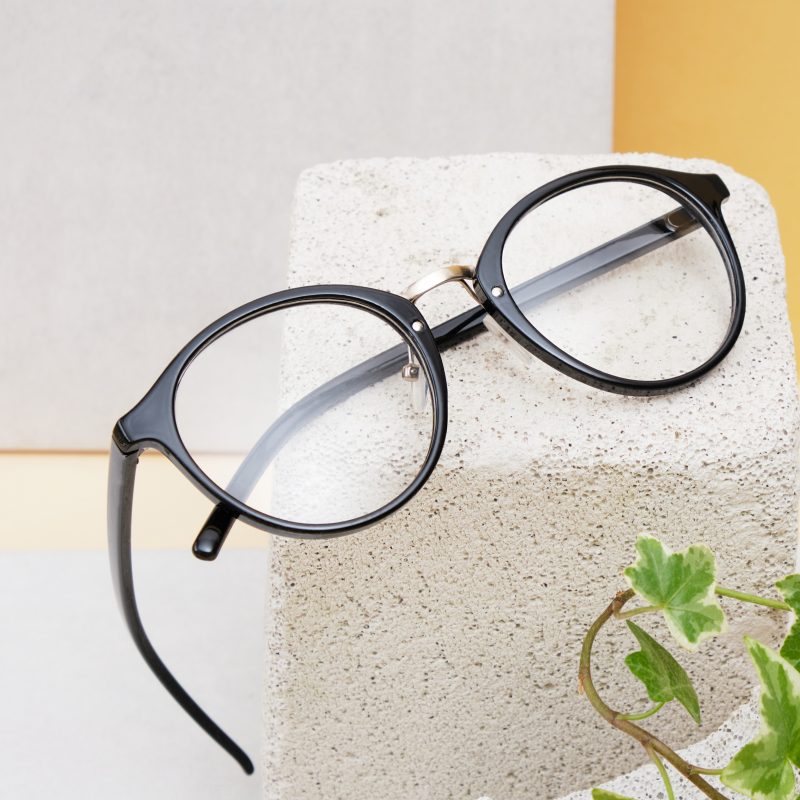 black eyeglass frames on stone block