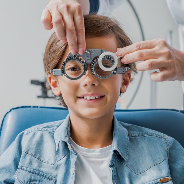young boy trying new eyeglass prescription 640x640