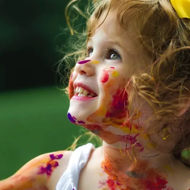 little girl with paint on face
