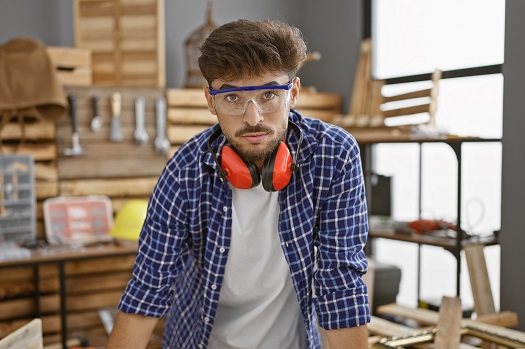male carpenter wearing safety glasses