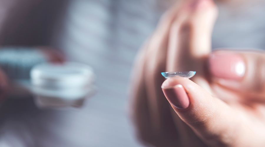 Woman holding contact lens2