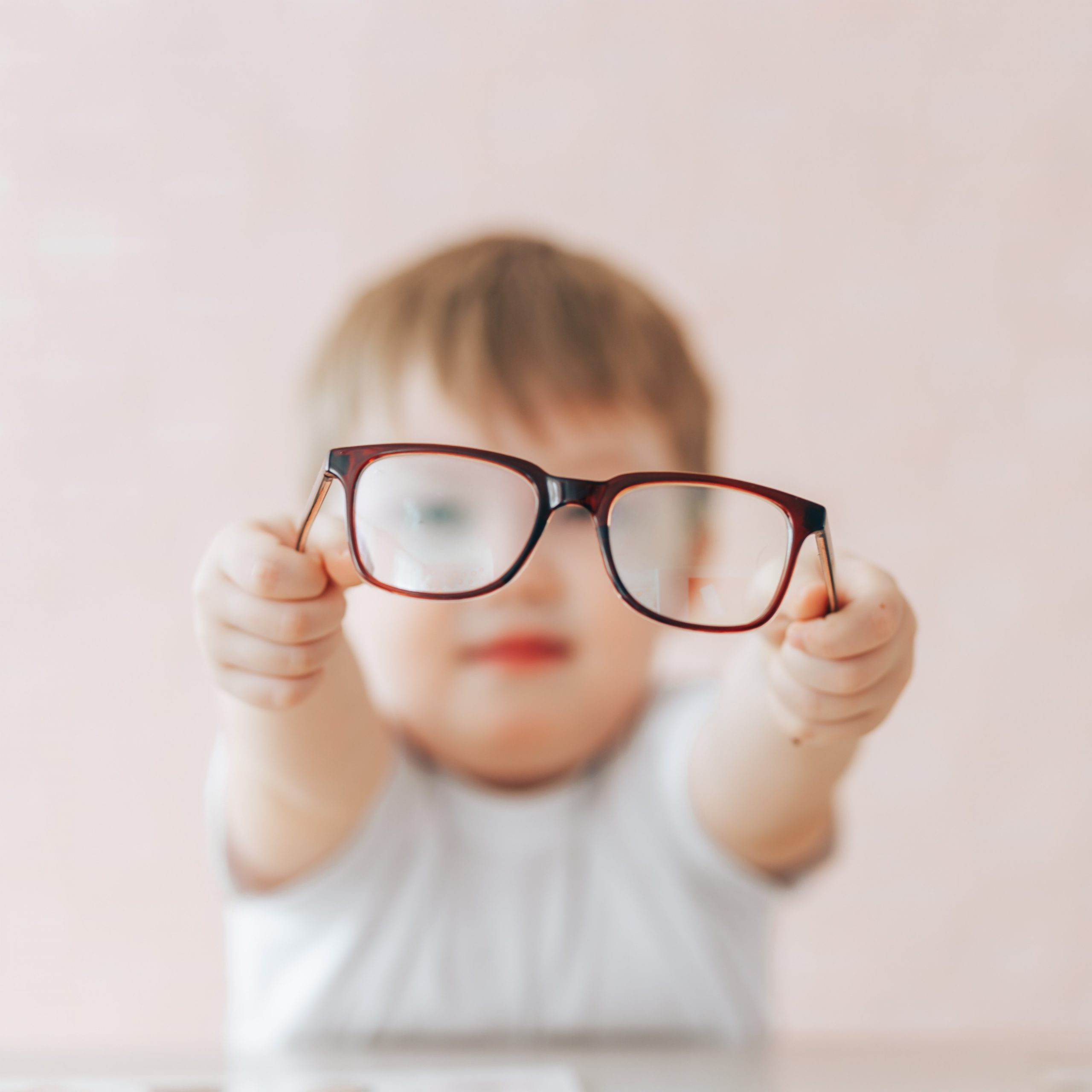 Child holding up eyeglasses