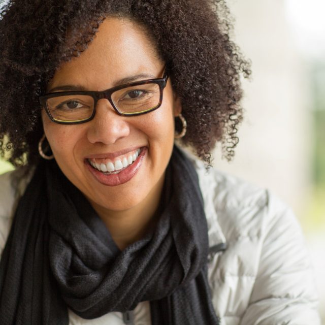 portrait of smiling woman in eyeglasses