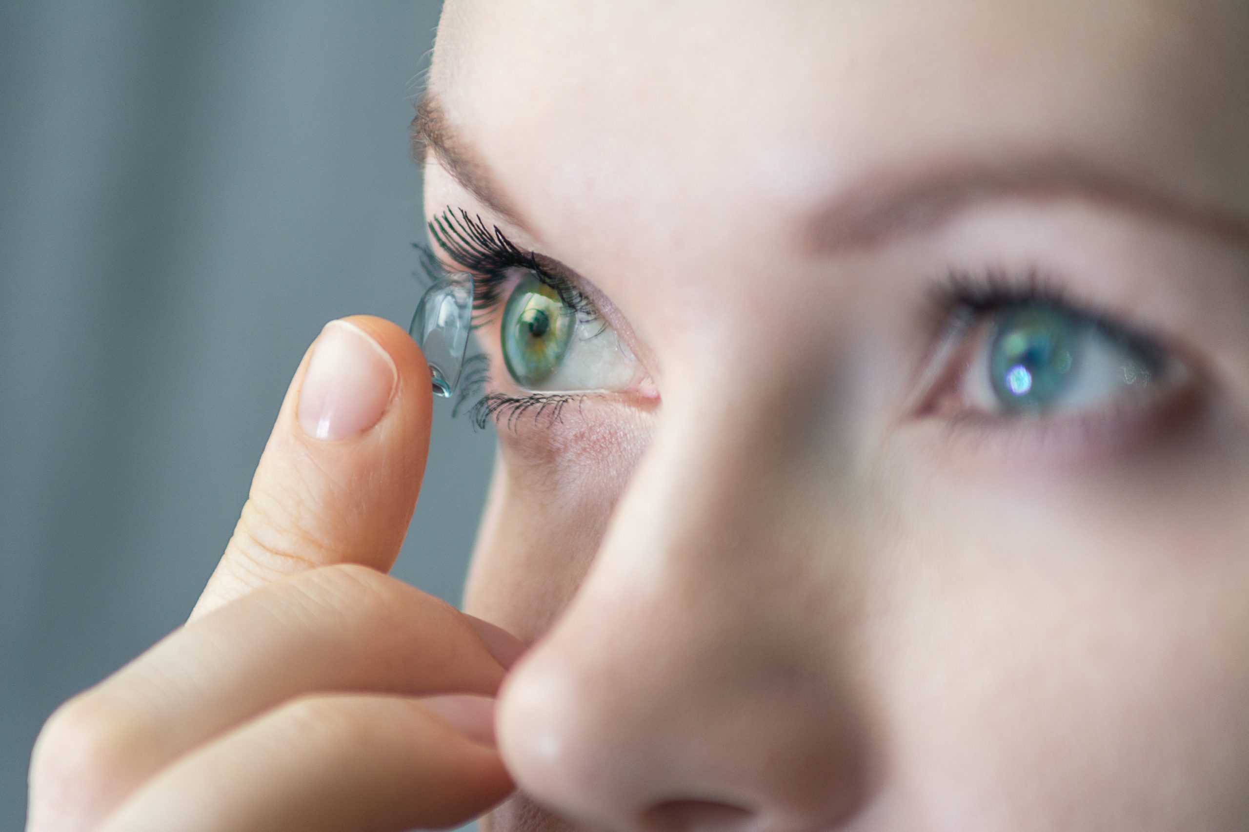 Girl wearing soft contact lenses close-up macro