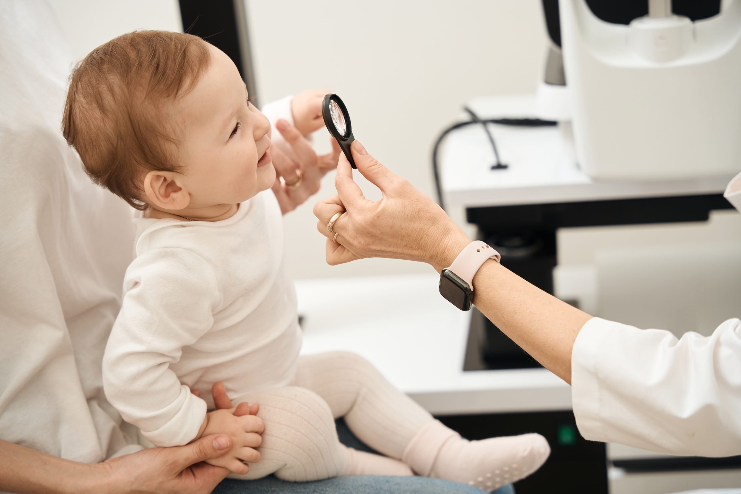Pediatric oculist checking child vision during consultation