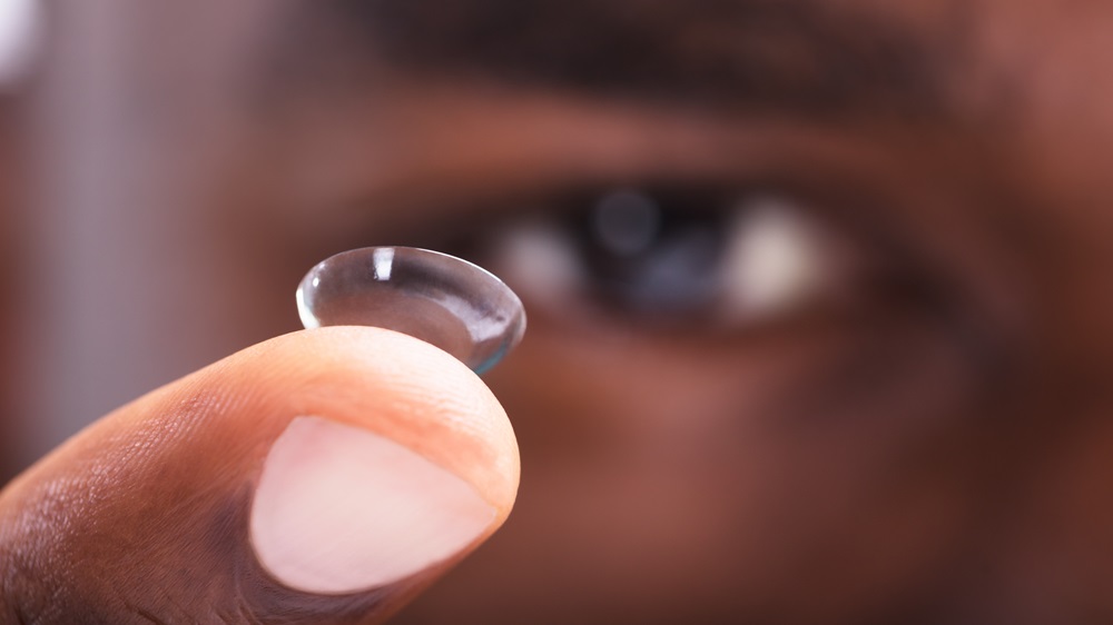 Man Holding Contact Lens On His Finger