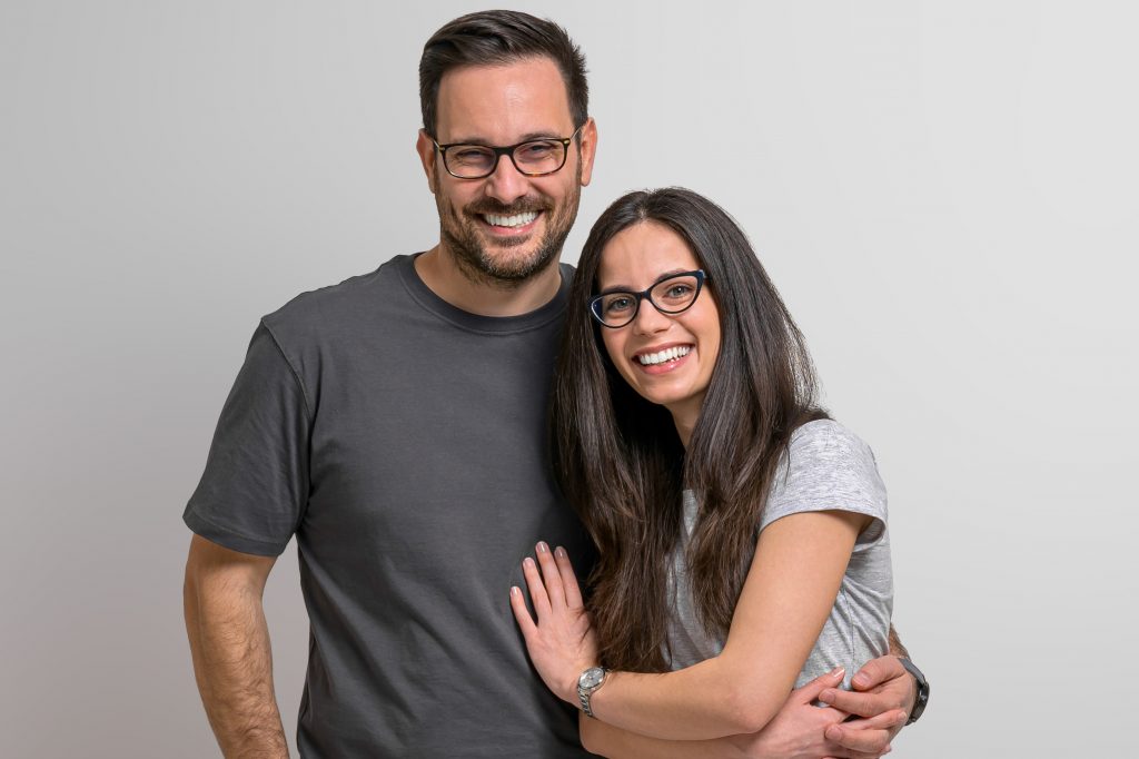 portrait of cheerful couple wearing eyeglasses
