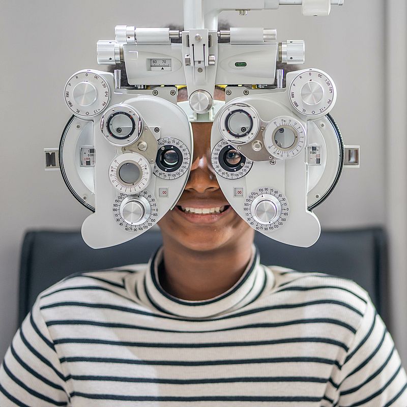 Close up Of african teen girl Doing Eye Test On Phoropter, Afric