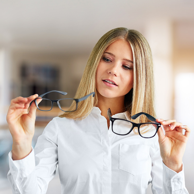 Pensive woman with glasses in a business center