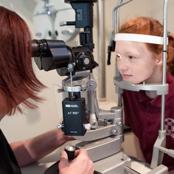optometrist and young patient eye exam