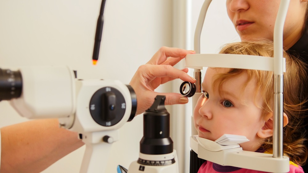 Optometrist checks girl's eyesight