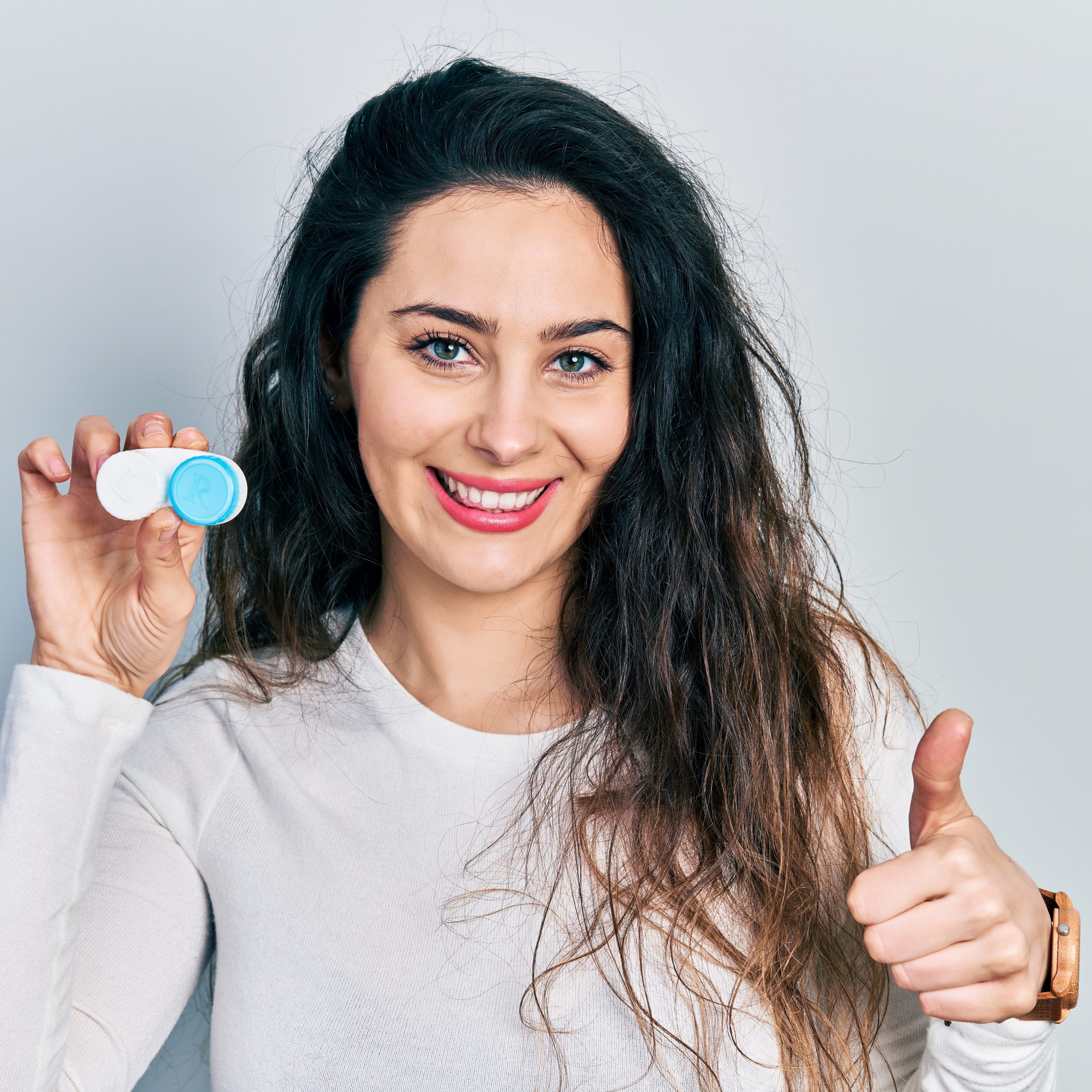 Woman holding contact lens case