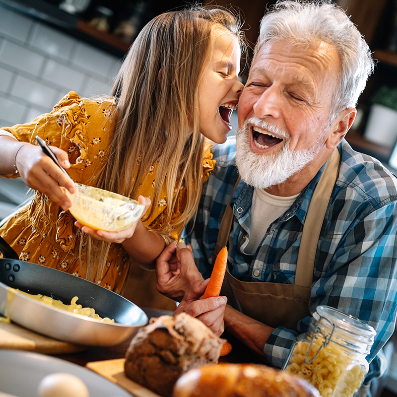 Grandfather and his grandchildren spendig happy fun time in kitchen
