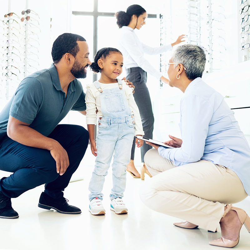 Optometrist, father and child for eye care, optometry or vision assessment or test in clinic or store. Man, senior woman or girl kid at optician for eyesight