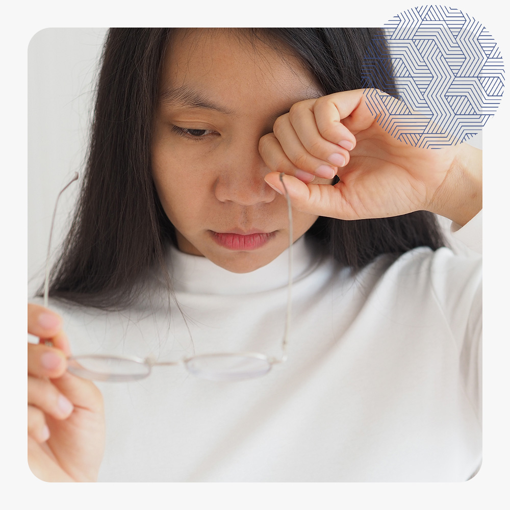 diabetic retinopathy in asian women and she is touching eye, symptoms of blurred vision and eye floaters or transparent and colorless spots..