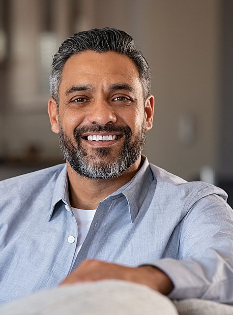 happy Indian man wearing contact lenses