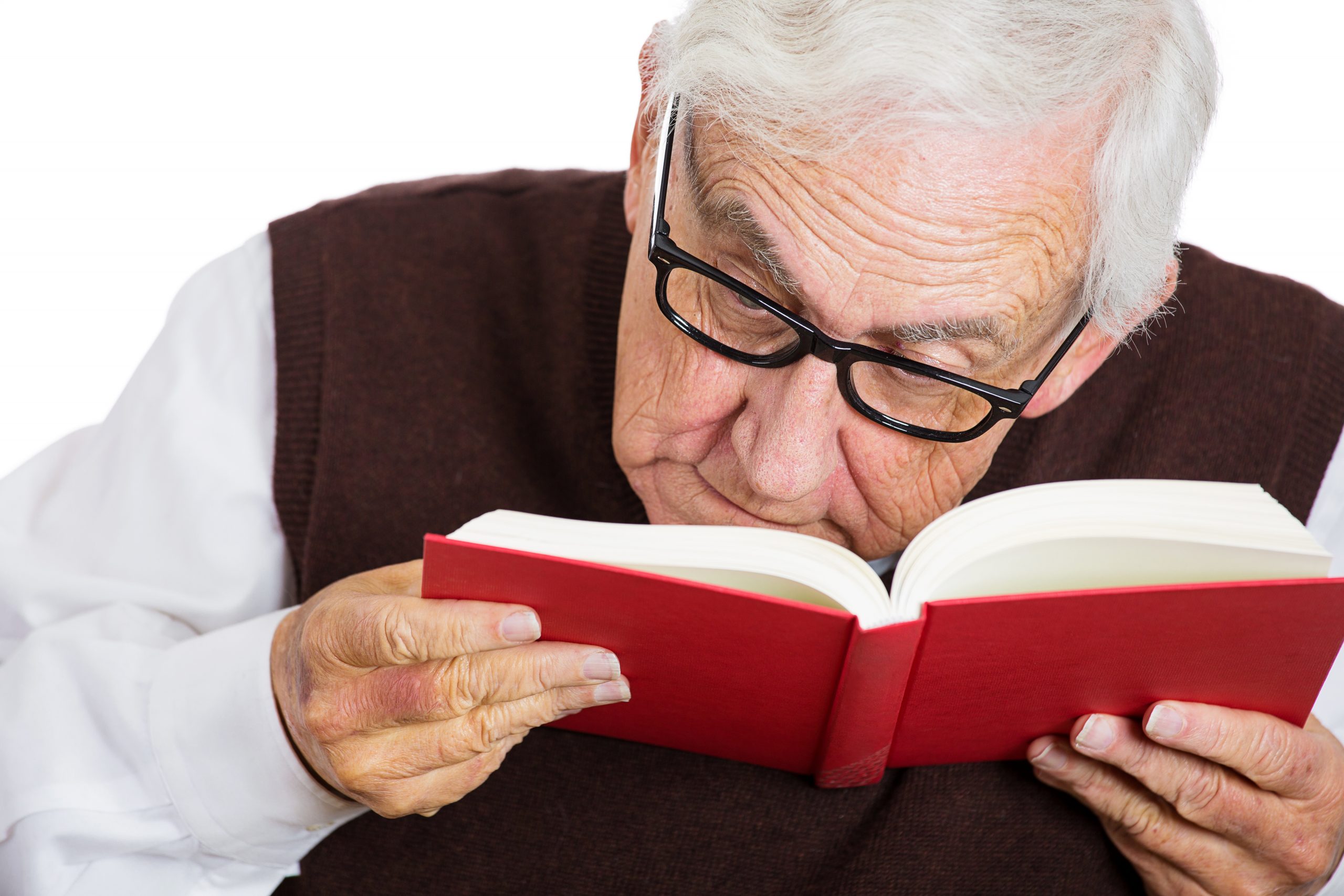 Old man in glasses having difficulties to read a book