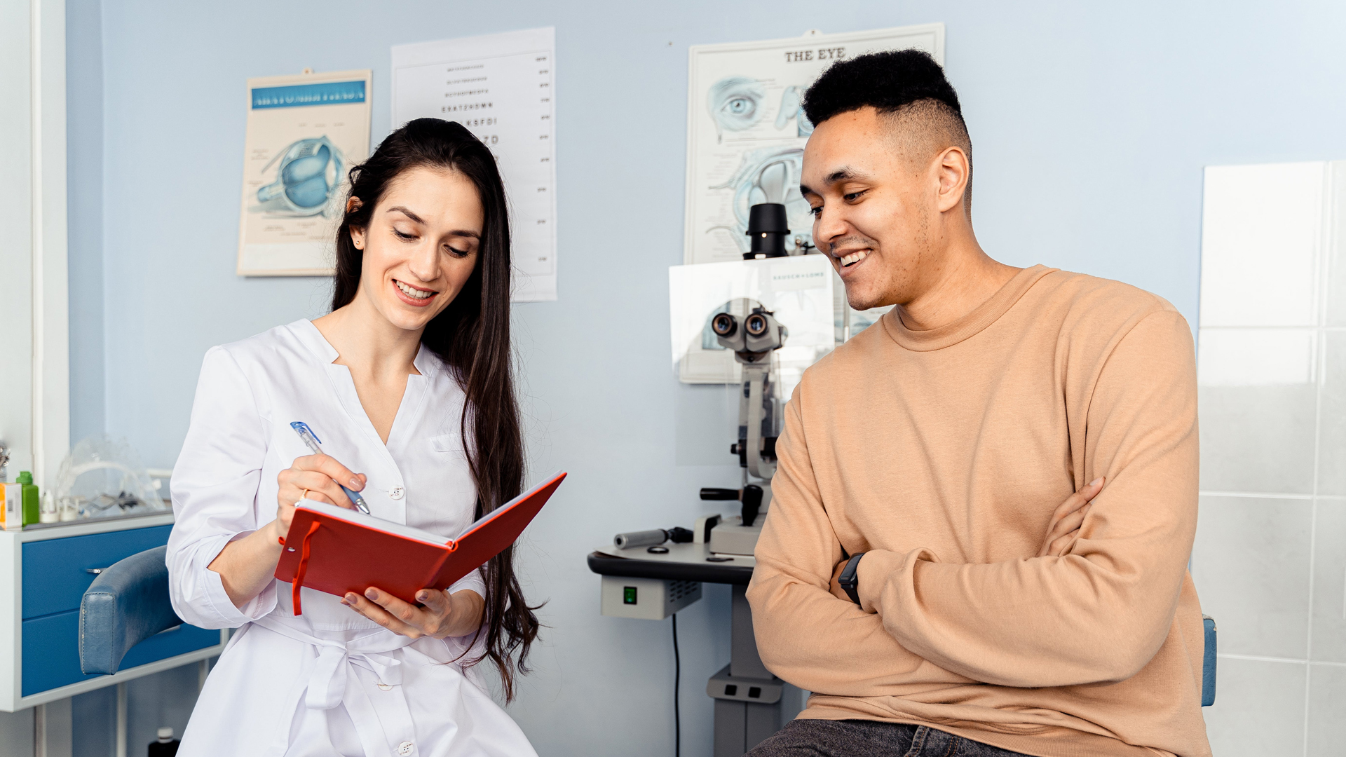 young caucasian optometrist in consultation with young hispanic patient