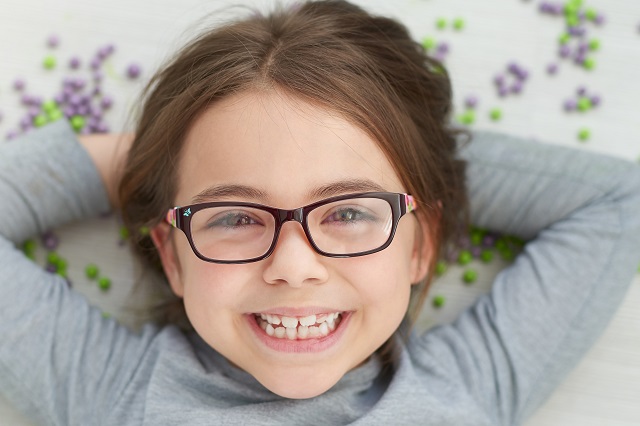 happy little girl wearing eyeglasses