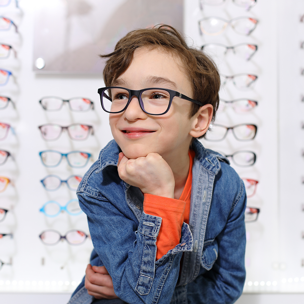 boy in glasses , at optics store