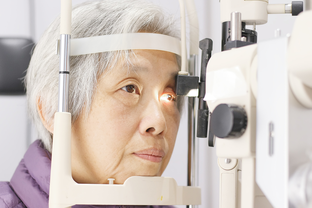 Senior asian woman having eyes tested for eye disease