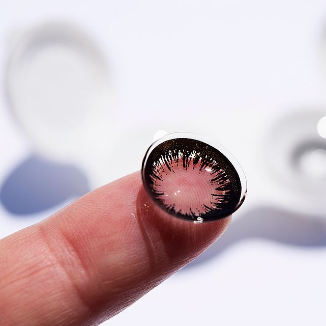 colored contact lens on finger