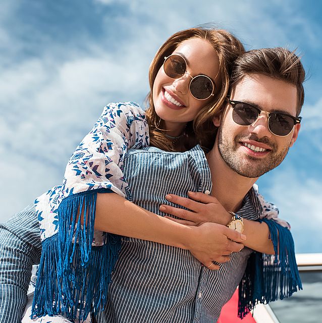 couple wearing sunglasses on a boat