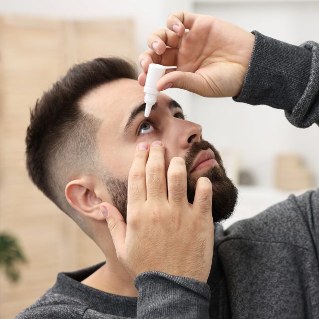 young man applying medical eye drops 640x640
