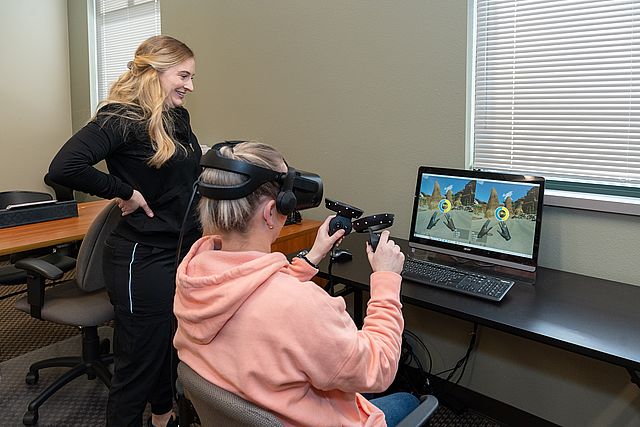 woman with virtual reality on computer