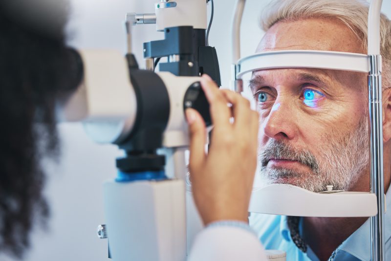 man behind glaucoma testing equipment
