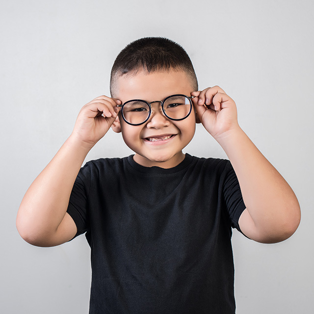 cute young boy smiling wearing eyeglasses
