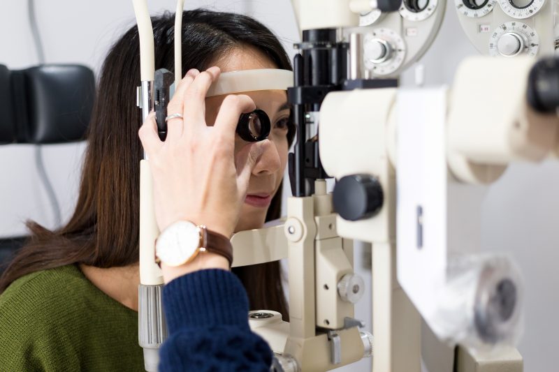 woman checking vision with tonometer