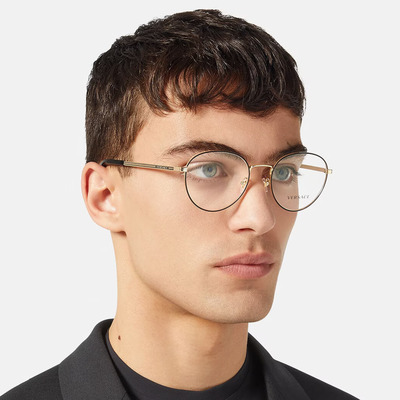 man wearing round golden versace eyeglasses