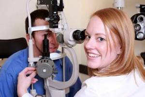 Doctor giving eye exam in Olathe, KS