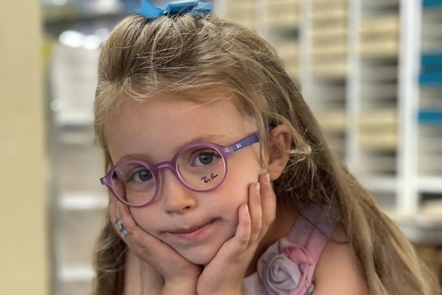 little girl wearing round purple eyeglasses 640x427