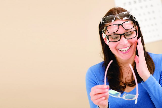 Woman wearing multiple pair of eyeglasses in Madison, WI