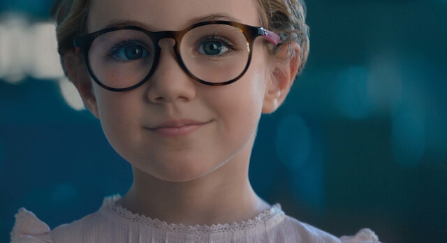 little girl wearing essilor stellest lenses