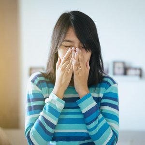 Girl sneezing from allergies in Oak Brook, Illinois