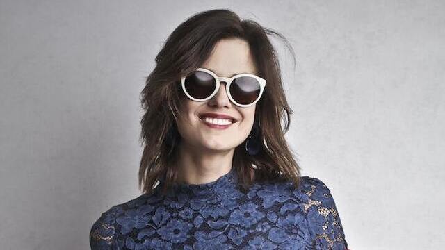 happy woman wearing white sunglasses
