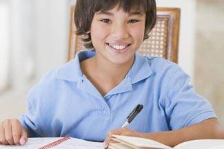 boy with blue shirt studying