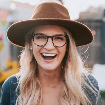 Woman wearing glasses, laughing