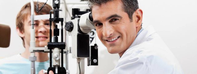 Optometrist, teenage boy at an eye exam on Nesconset, NY