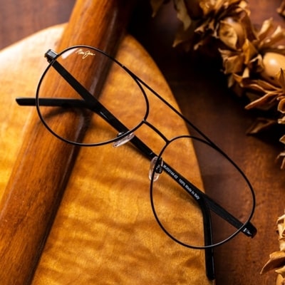pair of stylish maui jim eyeglasses on wooden background 400x400