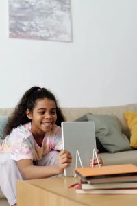Girl smiling while looking at screen