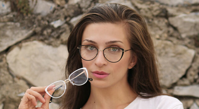 girl holding a pair of glasses 640