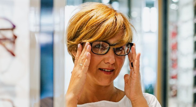 woman trying on a new pair of eyeglasses