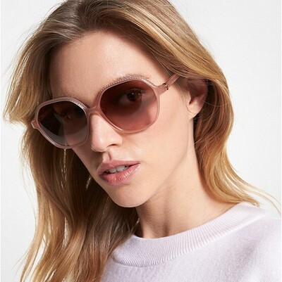 blond woman wearing pink colored michael kors sunglasses