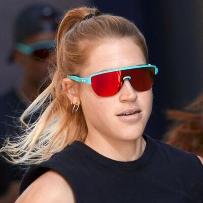 blond woman wearing red tinted oakley sunglasses