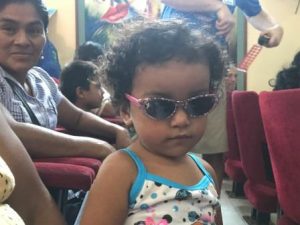 little girl in Peru with new sunglasses, donated by eye care mission from Colorado Springs, CO