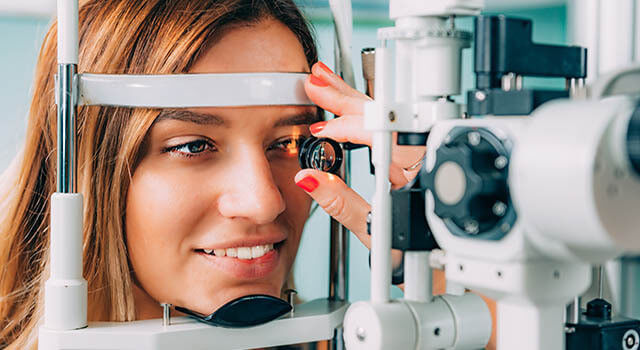 woman having an eye exam in Colorado Springs, CO